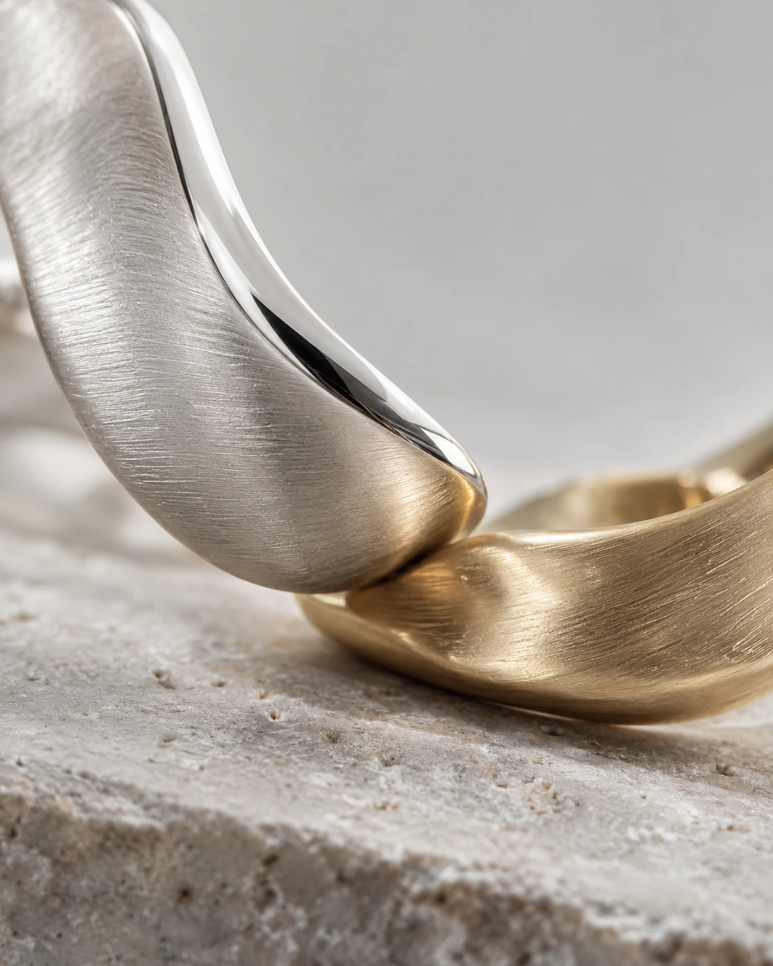 Brushed silver, polished edges and champagne gold — editorial material study